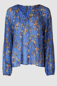 Cornflower blue pull on semi sheer top with long sleeves and elasticated cuffs v neck and flat piping detail