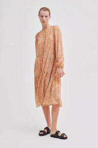 Midi length long sleeved dress with two tiers and full length placket