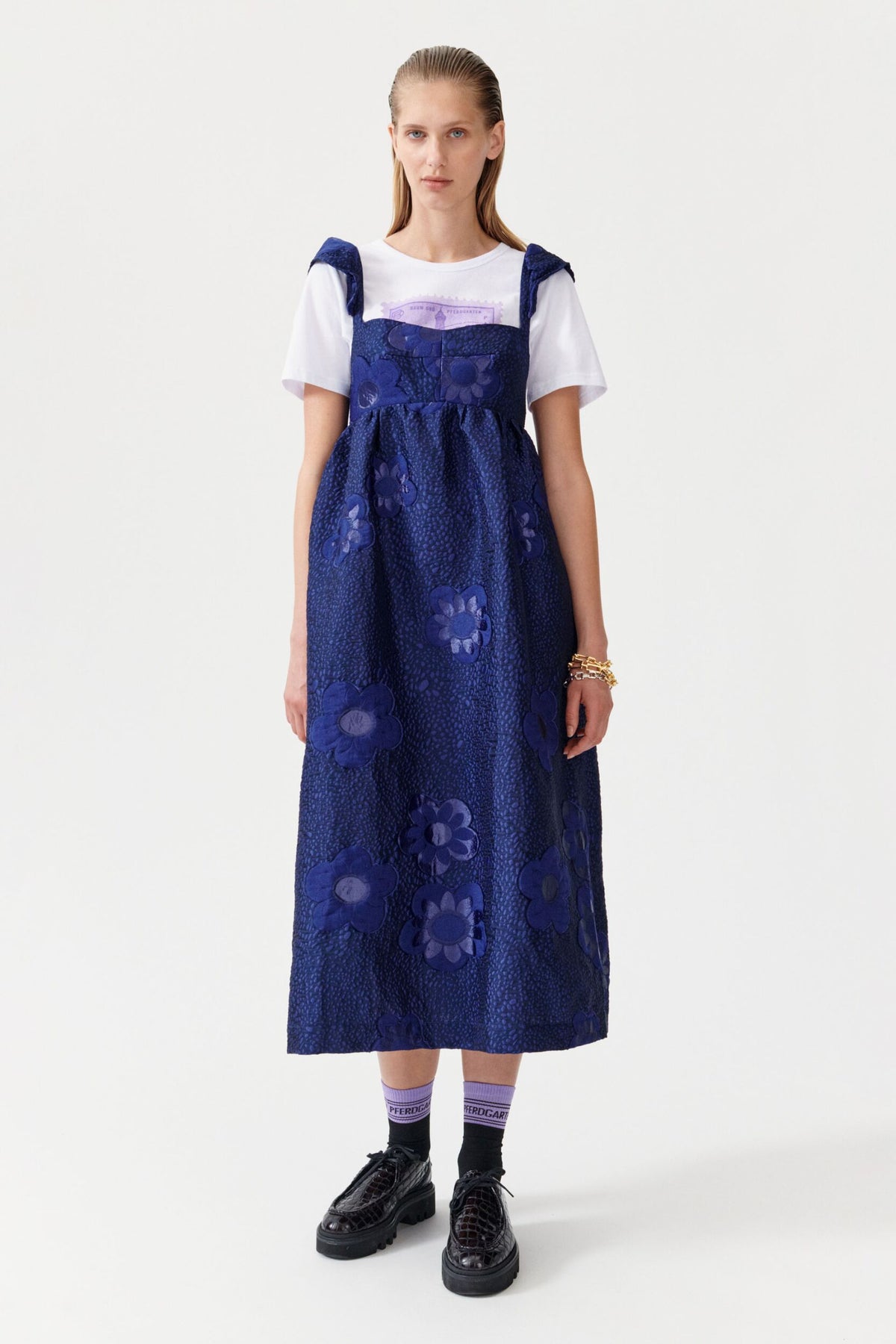Navy thin strappy dress with empire line and blue embroidered flowers on the fabric, full skirt midi length
