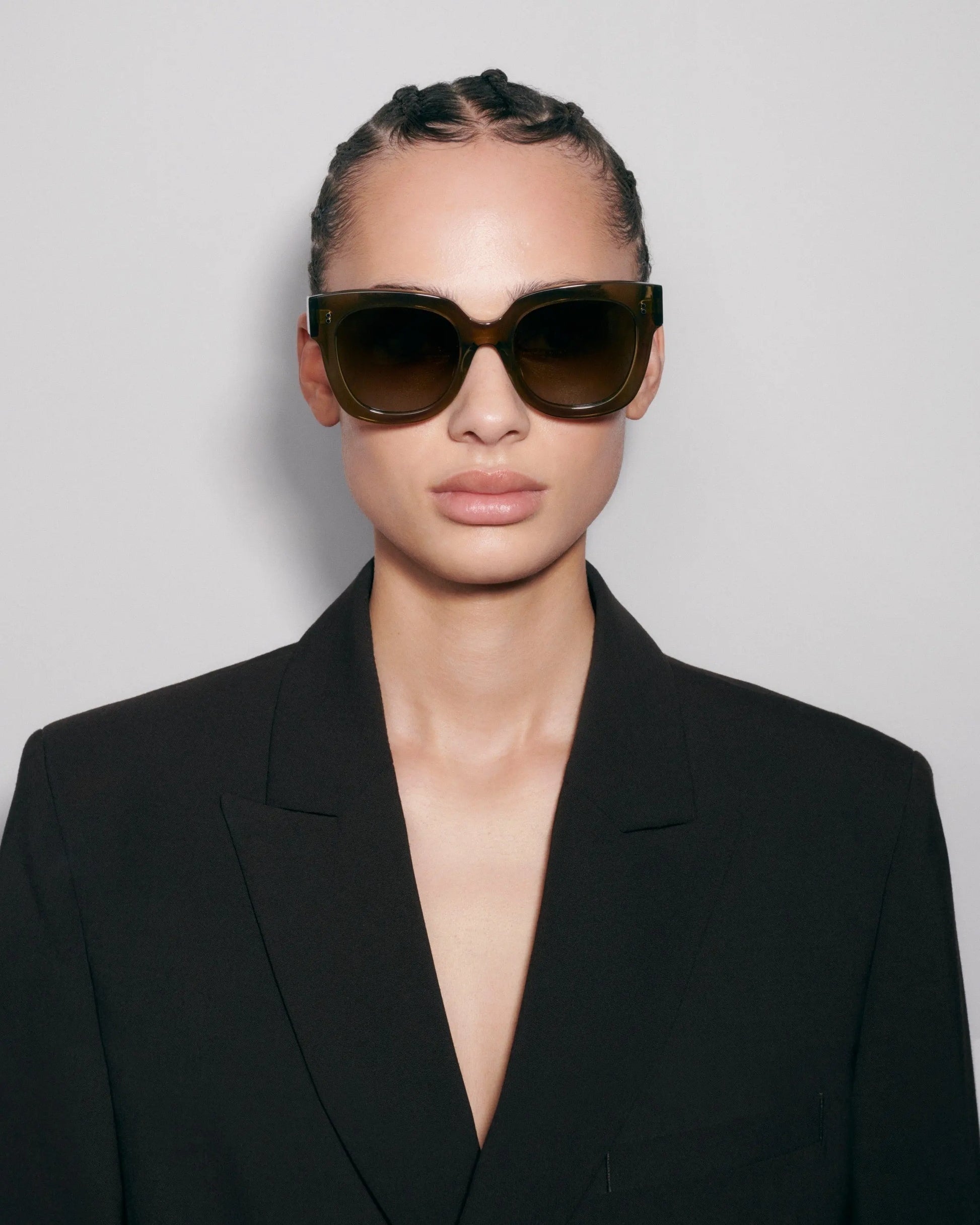 Oversize green sunglasses on model