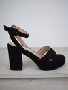 Suede black platform sandal with cross straps and ankle strap with buckle fastening