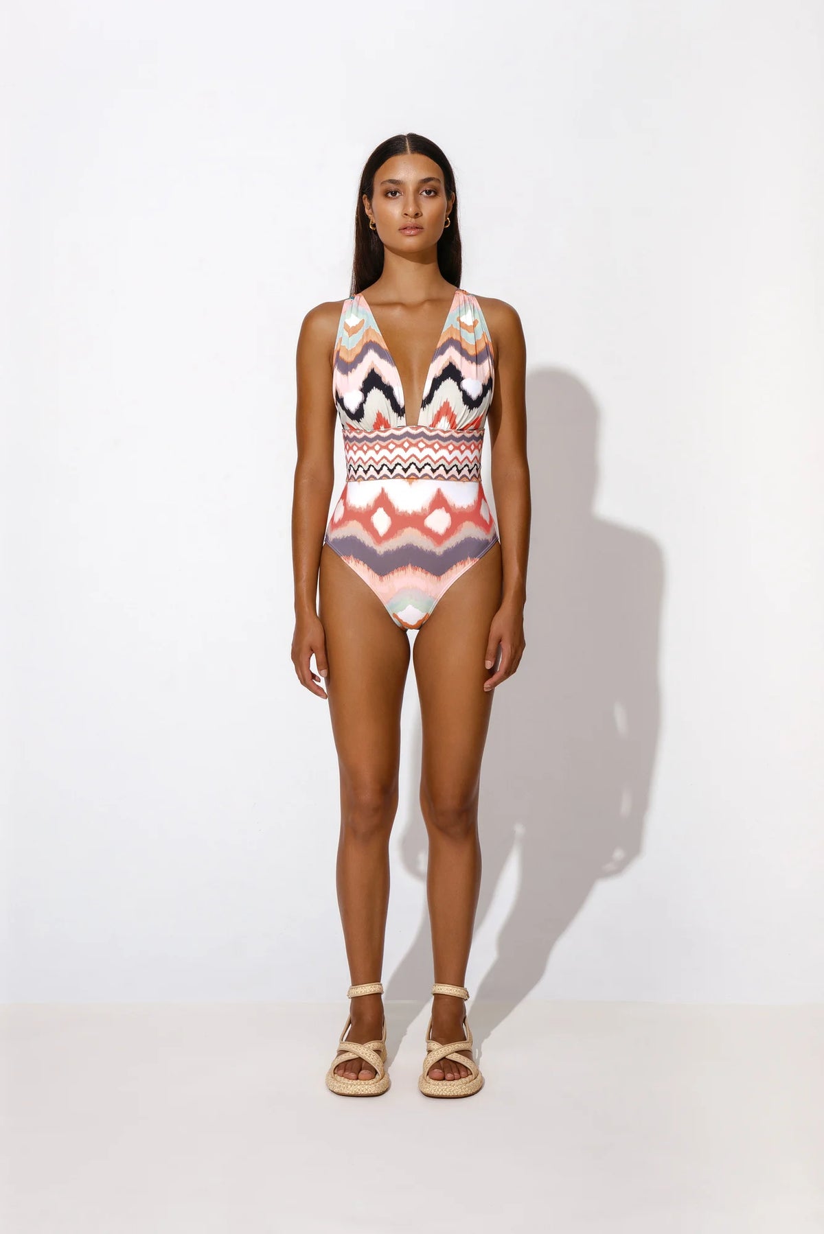 Multicoloured swimsuit with plunging V neckline enhanced waist high legs and gathering at the shoulders