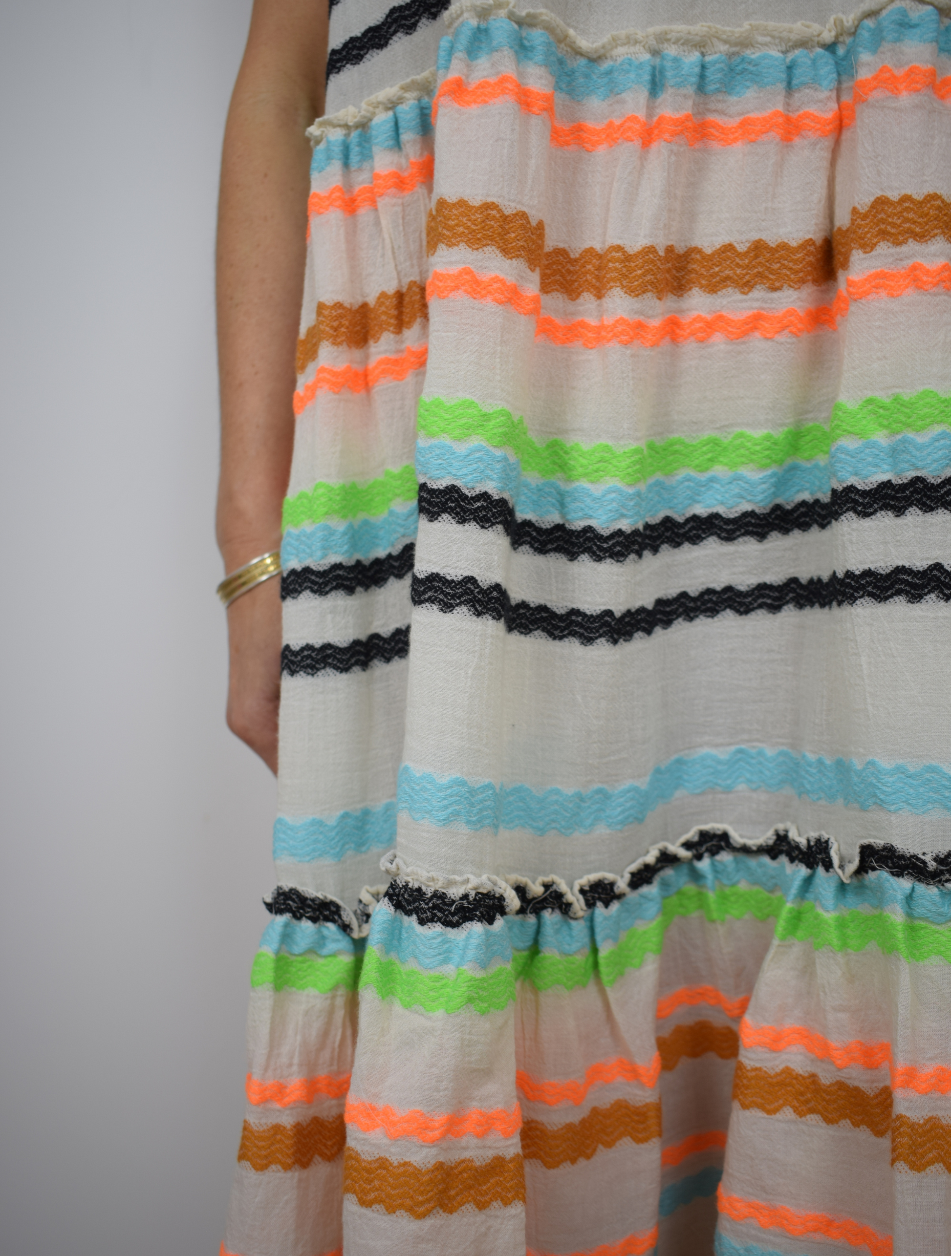 Ecru dress with blue, black, orange and brown frill stripes 