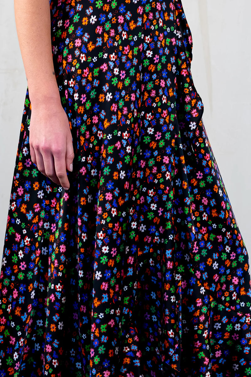 Faux wrap maxi dress in black with vibrant small floral hand drawn print in green, orange, pink, blue with short floaty sleeves