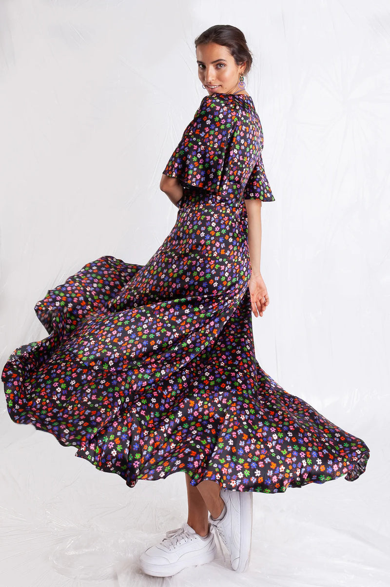 Faux wrap maxi dress in black with vibrant small floral hand drawn print in green, orange, pink, blue with short floaty sleeves