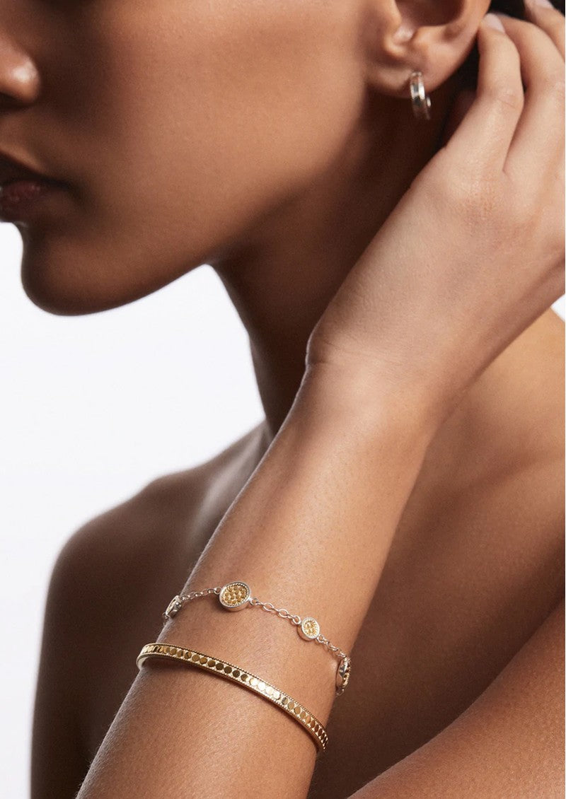 Classic Station bracelet in sterling silver and 18k gold worn with a gold stacking cuff