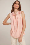 Sleeveless coral top with frayed collar and tie details