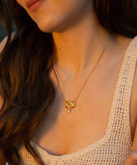 Gold plated twisted knot pendant with single freshwater drop pearl