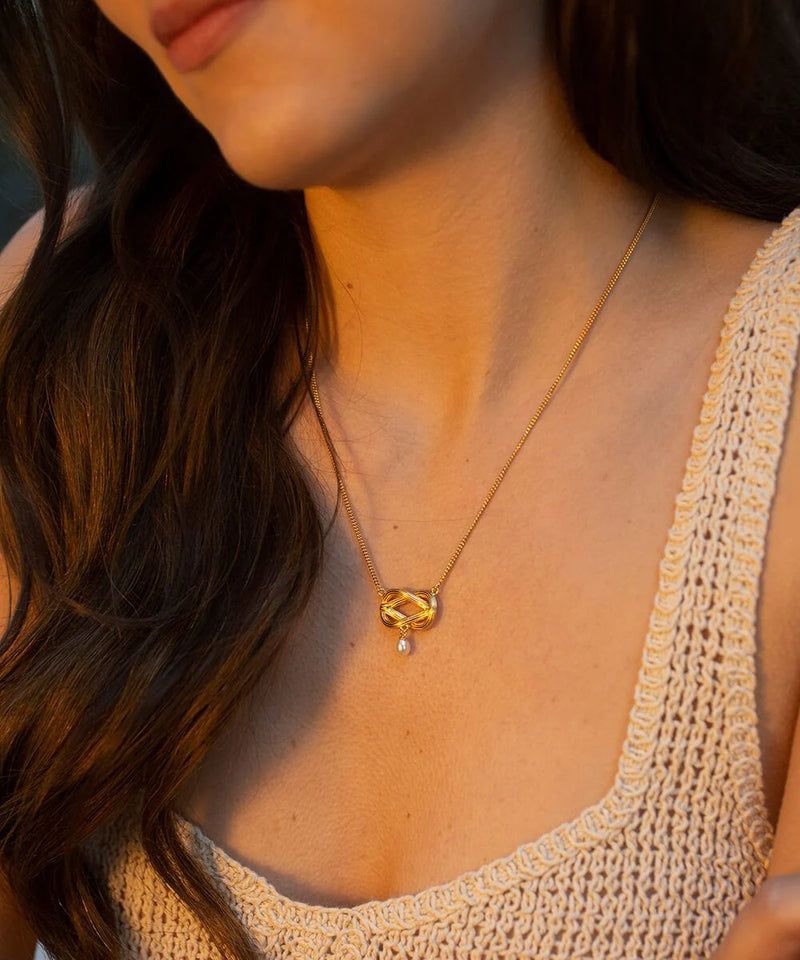 Gold plated twisted knot pendant with single freshwater drop pearl