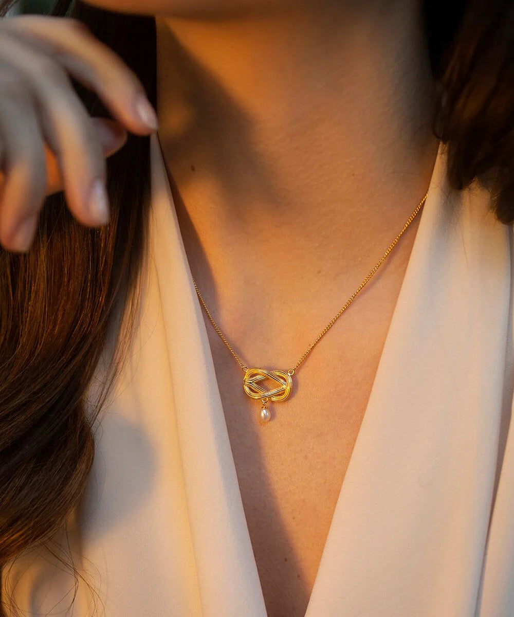 Gold plated twisted knot pendant with single freshwater drop pearl