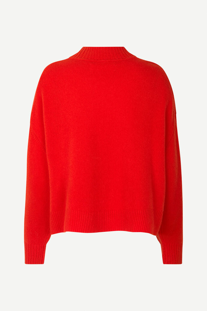 Red V neck wool jumper with long sleeves and ribbed detail