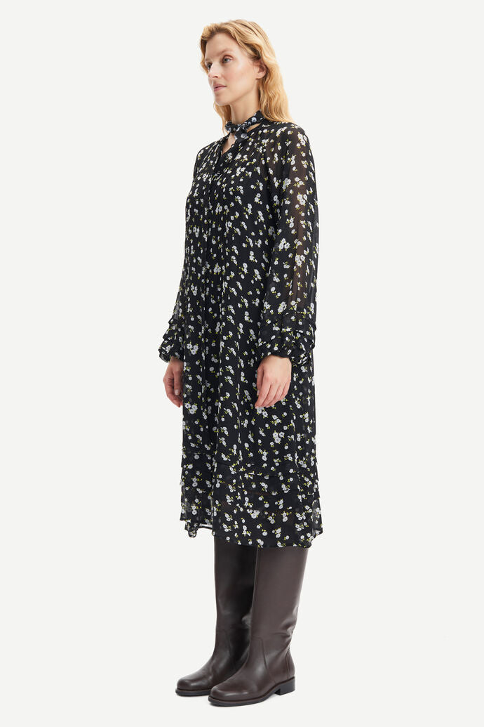 Black chiffon midi dress with tie neck and white and yellow ditsy floral print long sleeves and tie neck