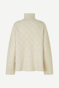 Turtle neck ecru cable knit jumper with wide ribbed hem cuffs long sleeves and two side vents
