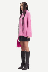 Pink turtleneck jumper with dropped shoulders and long wide sleeves in a boucle like alpaca blend fabric