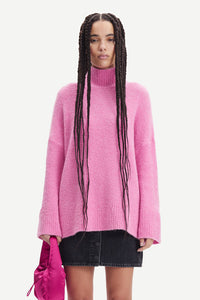 Pink turtleneck jumper with dropped shoulders and long wide sleeves in a boucle like alpaca blend fabric