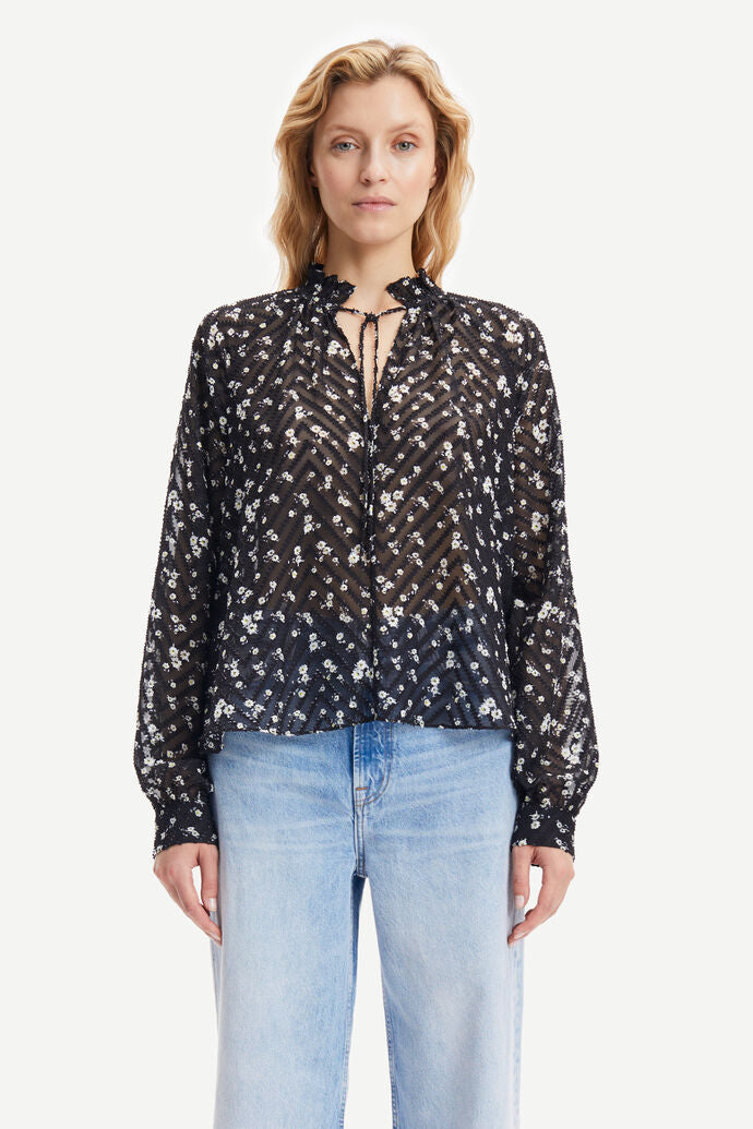 Semi sheer black and ditsy white floral blouse with high neck and ruffle collar long raglan sleeves with gathering and single button fastening cuff