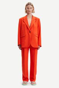 Orange tailored trousers with pleated front and fixed waistband