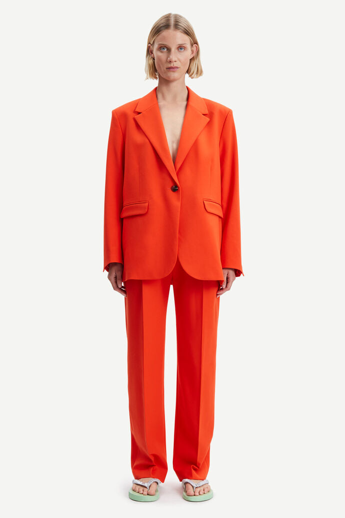 Orange tailored trousers with pleated front and fixed waistband