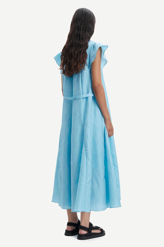 Long baby blue A line long dress with ruffle collar and capped sleeves made from a fabric embossed with small flowers