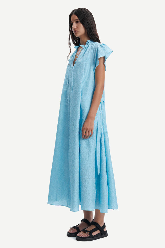 Long baby blue A line long dress with ruffle collar and capped sleeves made from a fabric embossed with small flowers