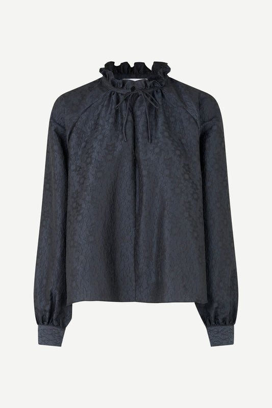 Navy tie neck blouse with long raglan sleeves in a deep navy embossed recycled polyester fabric