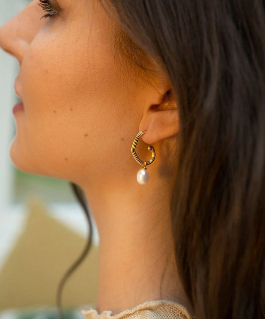 Gold plated grooved tubing hoop earrings with post and butterfly fastening and single freshwater pearl pendant