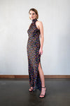 Black silk halterneck maxi dress with side split and vibrant ditsy floral print in vibrant colours