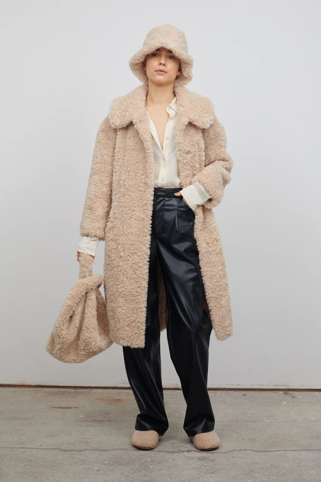 Midi length faux fur coat with large collar V neck and three popper fastenings
