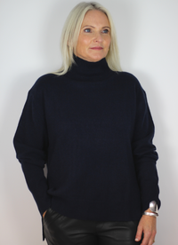 Midnight blue cashmere jumper with roll neck and ribbed step hem.