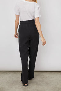 Long black cheese-cloth style wide leg trousers with side splits and elasticated waist with pockets