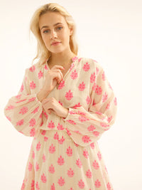 Ecru maxi dress with long sleeves and neon pink print and deep frill with shirred waist