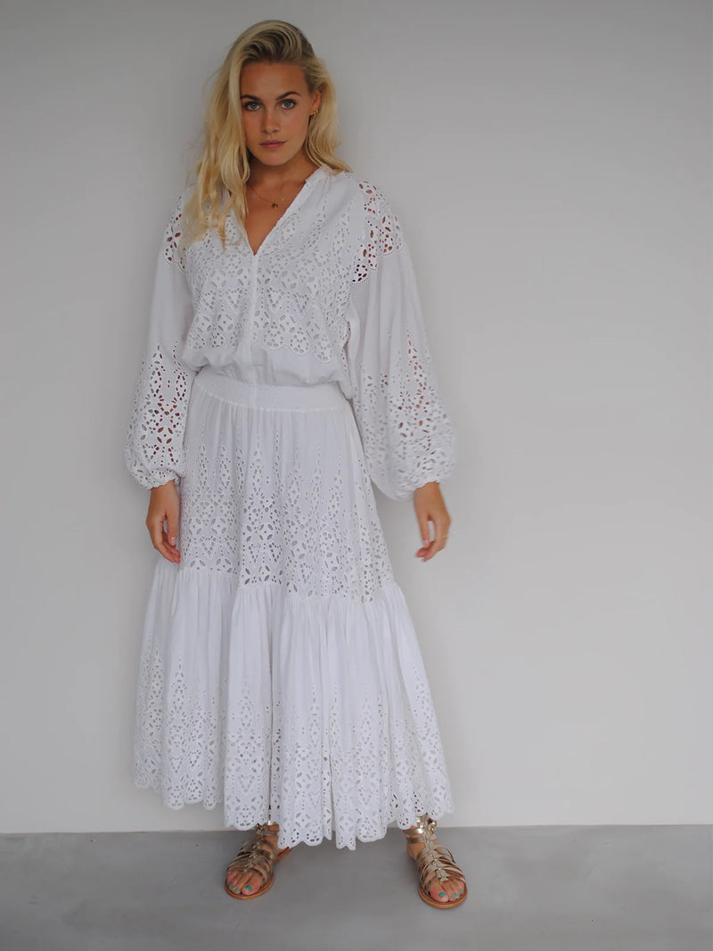 White maxi dress with broderie anglais and long puff sleeves with a shirred waist