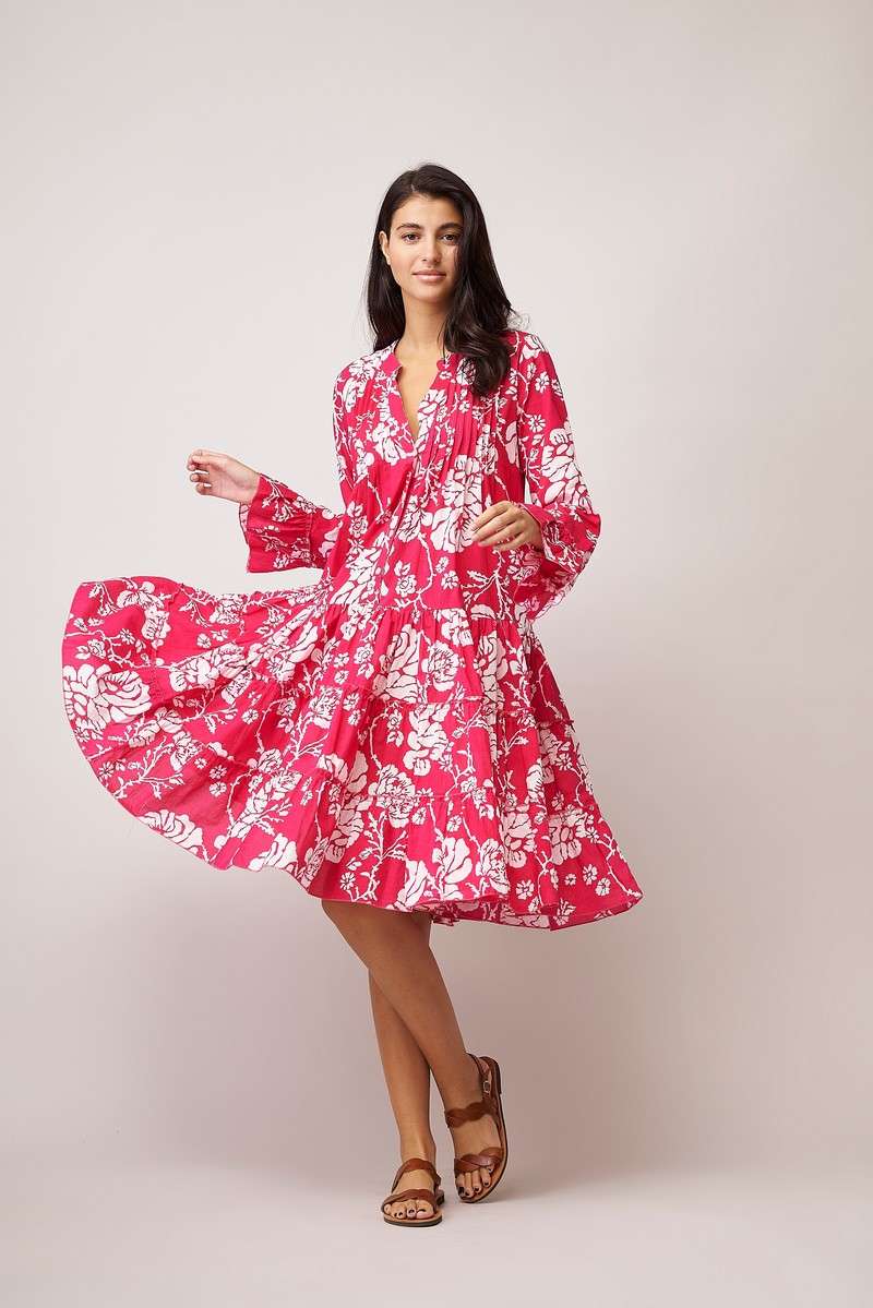 Knee length triple layered summer dress with long sleeves and ruffle cuffs, notch neck and half placket with button fastenings in magenta pink with all over white floral print