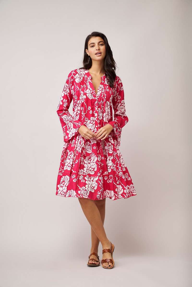 Knee length triple layered summer dress with long sleeves and ruffle cuffs, notch neck and half placket with button fastenings in magenta pink with all over white floral print