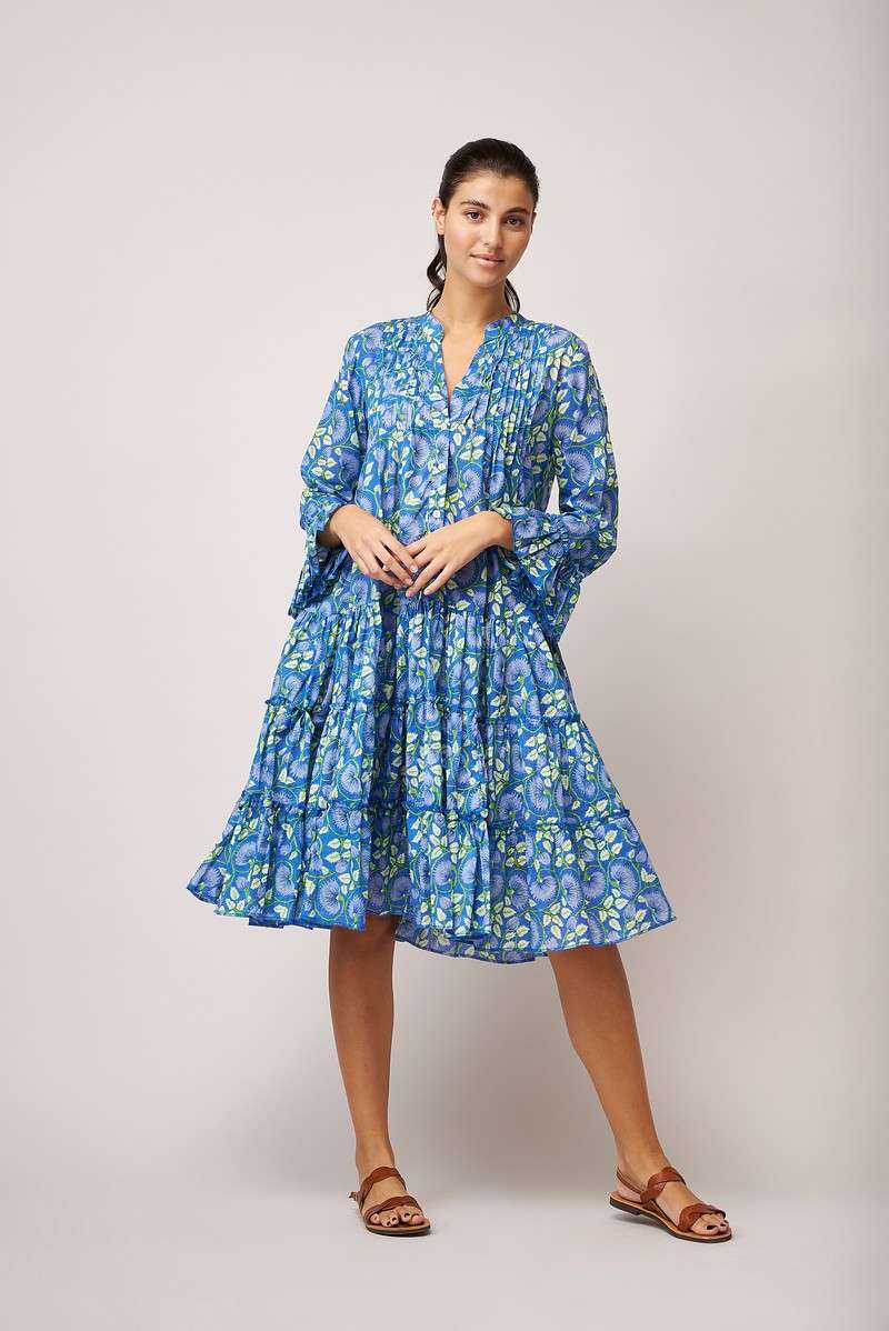 Knee length triple layered summer dress with long sleeves and ruffle cuffs, notch neck and half placket with button fastenings in denim blue with white and lime green all over floral print