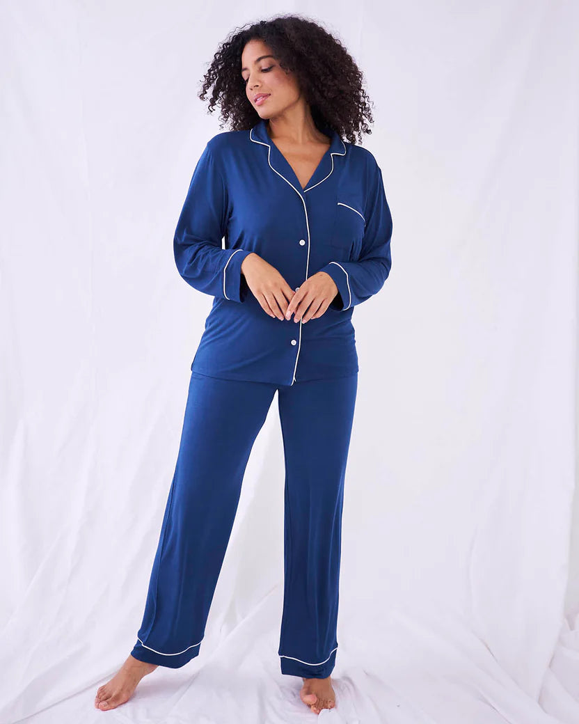 Midnight blue full length pyjamas with white piping trim and patch pocket and little white buttons