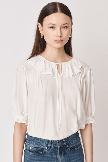 White pull on blouse with ruffle collar and tie detail elbow length sleeves with ruffle detail