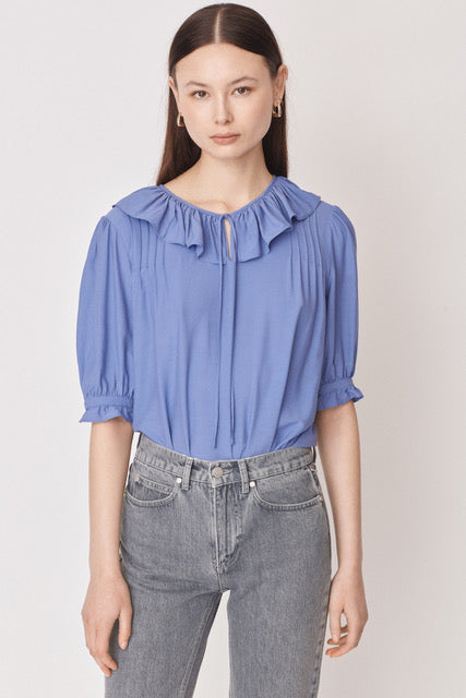 Lilac pull on blouse with ruffle collar and tie neck with short elbow length sleeves and ruffle cuffs