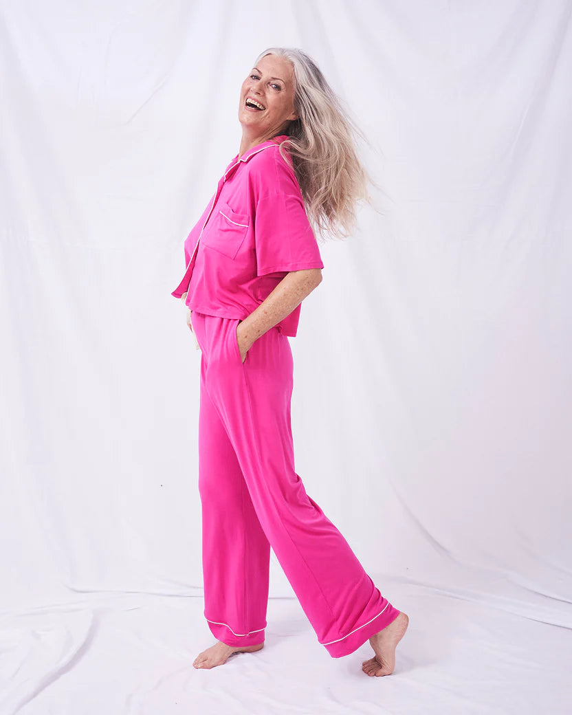 Boxy pyjama top and full length bottoms in a raspberry pink with white contrast piping and patch pocket