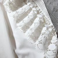 White cotton poplin shirt with classic collar lace ruffles on bodice and long sleeves with detachable black chiffon bow