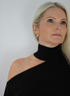 Black cashmere knitted dress with slash neck line and exposed right shoulder.