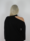 Black cashmere knitted dress with slash neck line and exposed right shoulder.