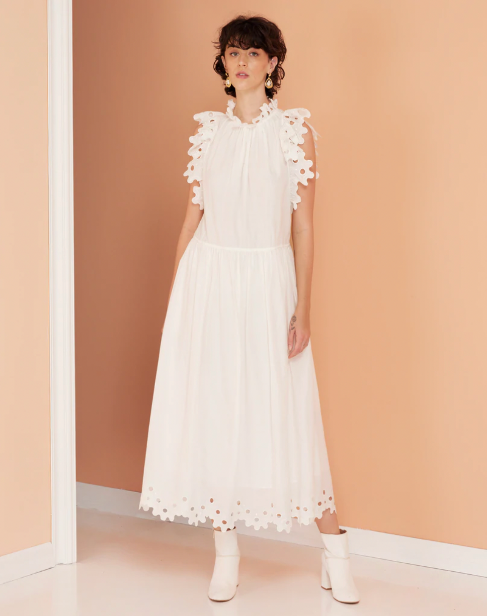 White dress with cut out details a ruffle sleeve and an open back