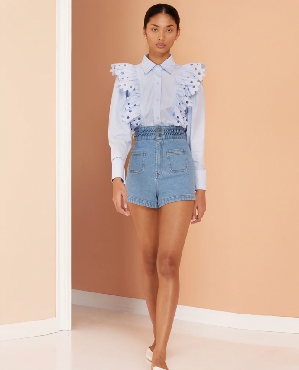 Pale blue cotton shirt with a classic collar and embroidered detail