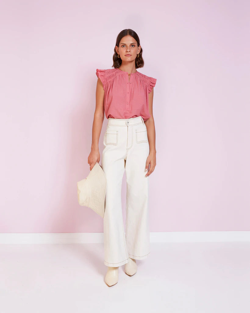 Blush pink top with pleating details at the shoulder