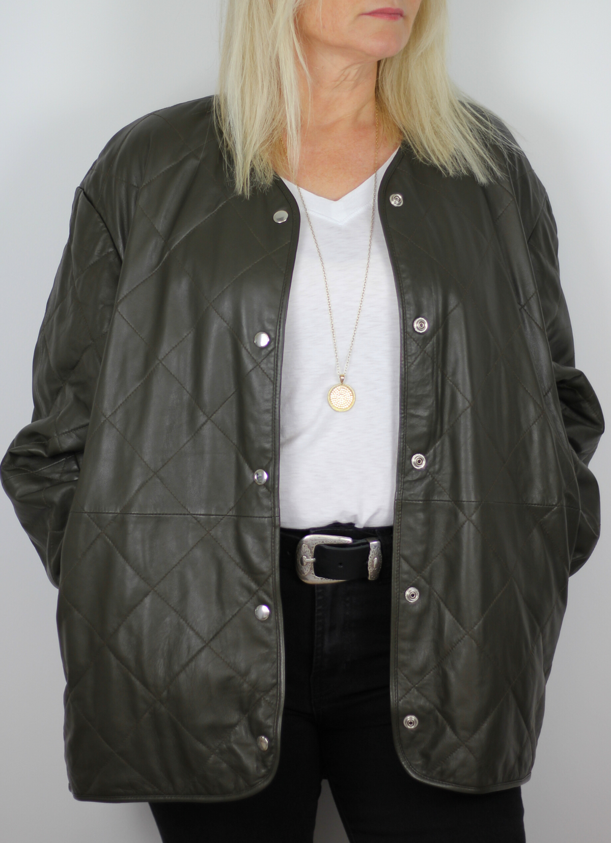 Dark green leather quilted jacket with silver popper buttons