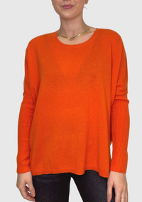 Bright orange cashmere jumper with a round neck and a boxy fit