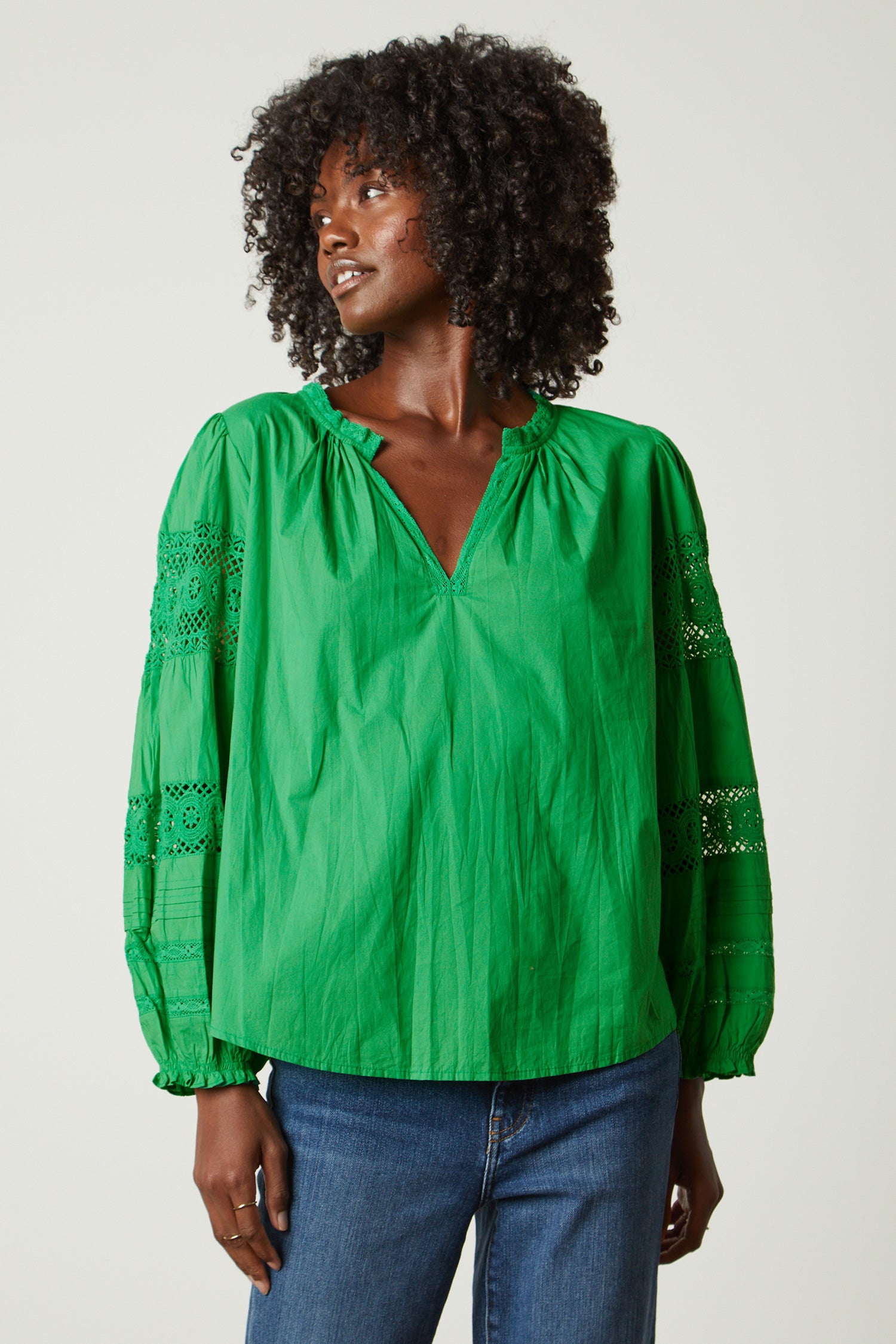 Green cotton top with notch neck and lace inserts in the long sleeves