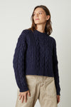 Navy cable knit short jumper with long sleeves and ribbed cuffs and crew neck