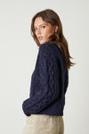 Navy cable knit short jumper with long sleeves and ribbed cuffs and crew neck
